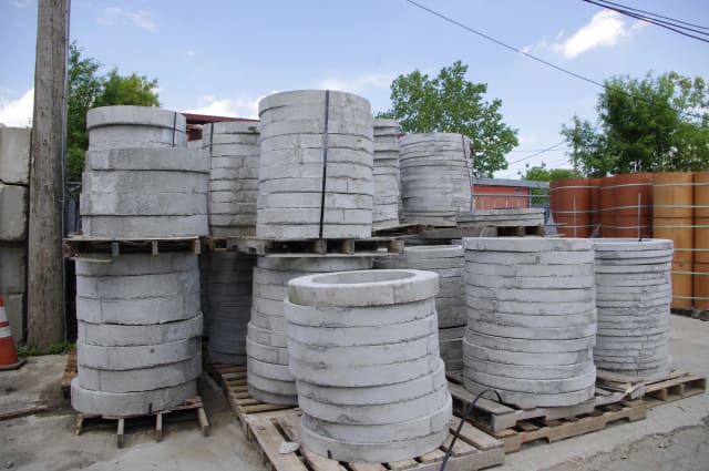 Concrete adjustment rings stacked in a supply yard