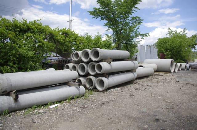 Concrete drainage pipe stored in an outdoor yard